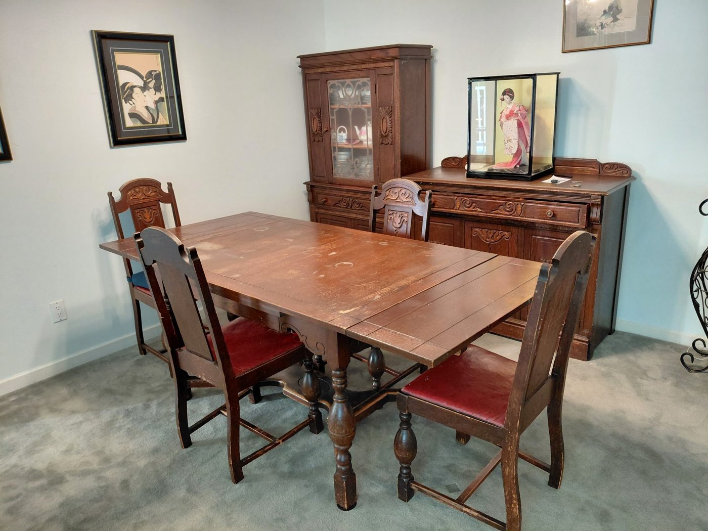 Antique dining table with four carved wooden chairs, a china hutch and a buffet, ready for furniture removal in Surrey