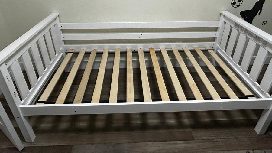 White wooden bed frame ready for removal