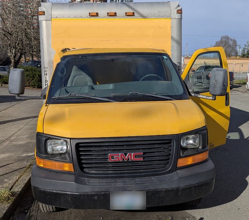 Yellow GMC box truck used by Junk Removal Express for same-day junk removal