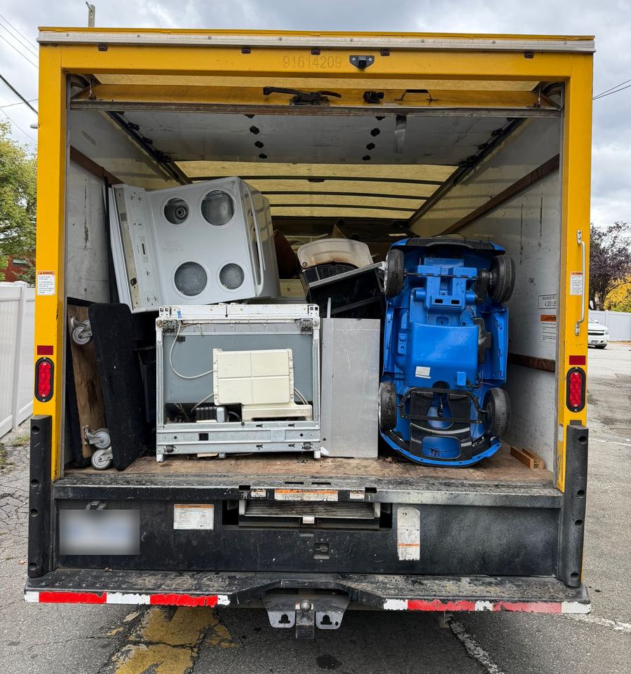 Junk Removal Express box truck loaded with a stove, washer and other appliances after a same-day junk removal pickup