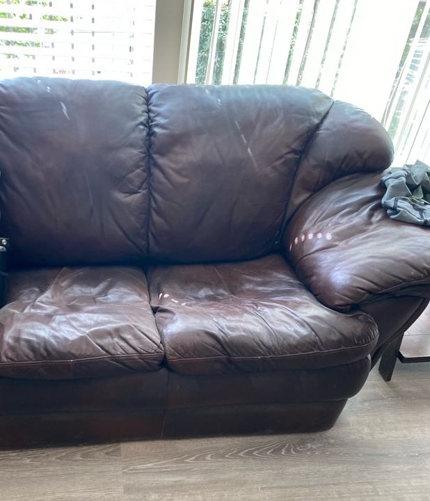 Brown leather loveseat ready for furniture removal