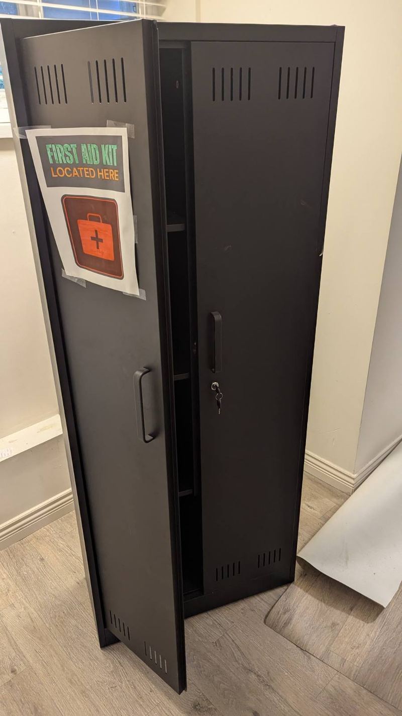 Tall black metal storage cabinet ready for removal
