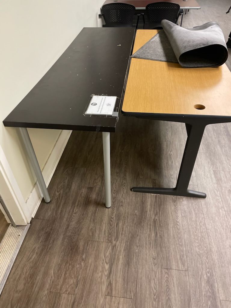 Two office desks ready for removal during an office cleanout