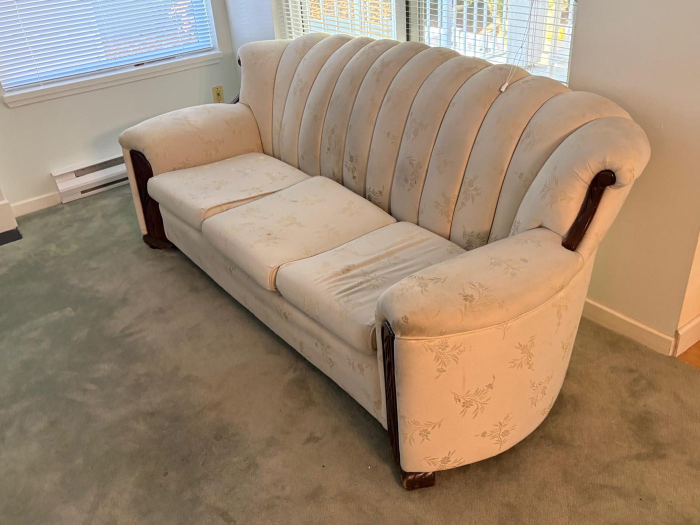 Cream channel-back vintage sofa with carved wood arms ready for couch removal in Surrey